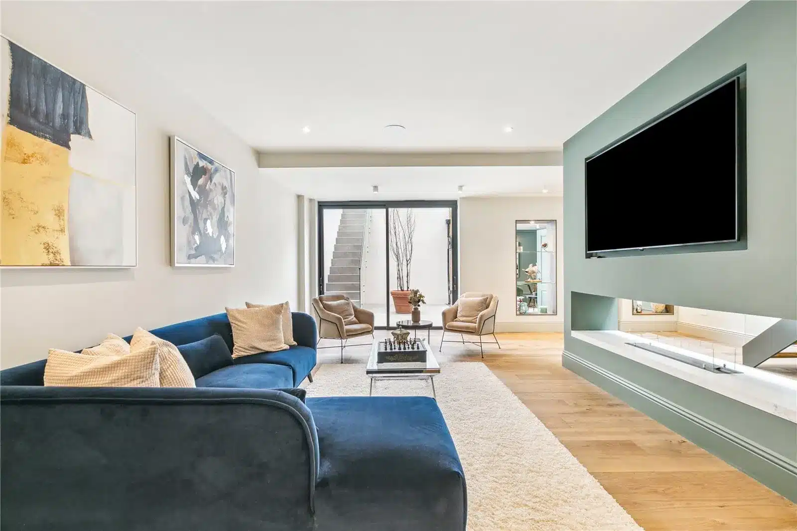 Lower-level living room with a glazed sliding door to a sunken courtyard and stair, Wandsworth