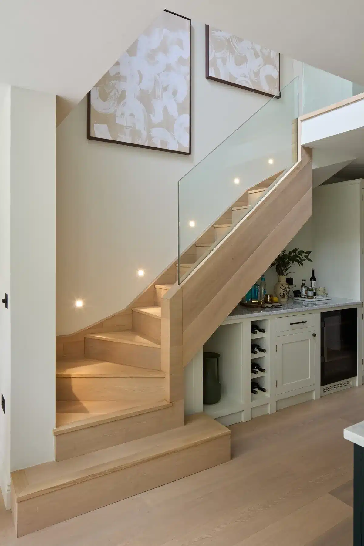 Oak and glass staircase leading down to a kitchen level, Fulham