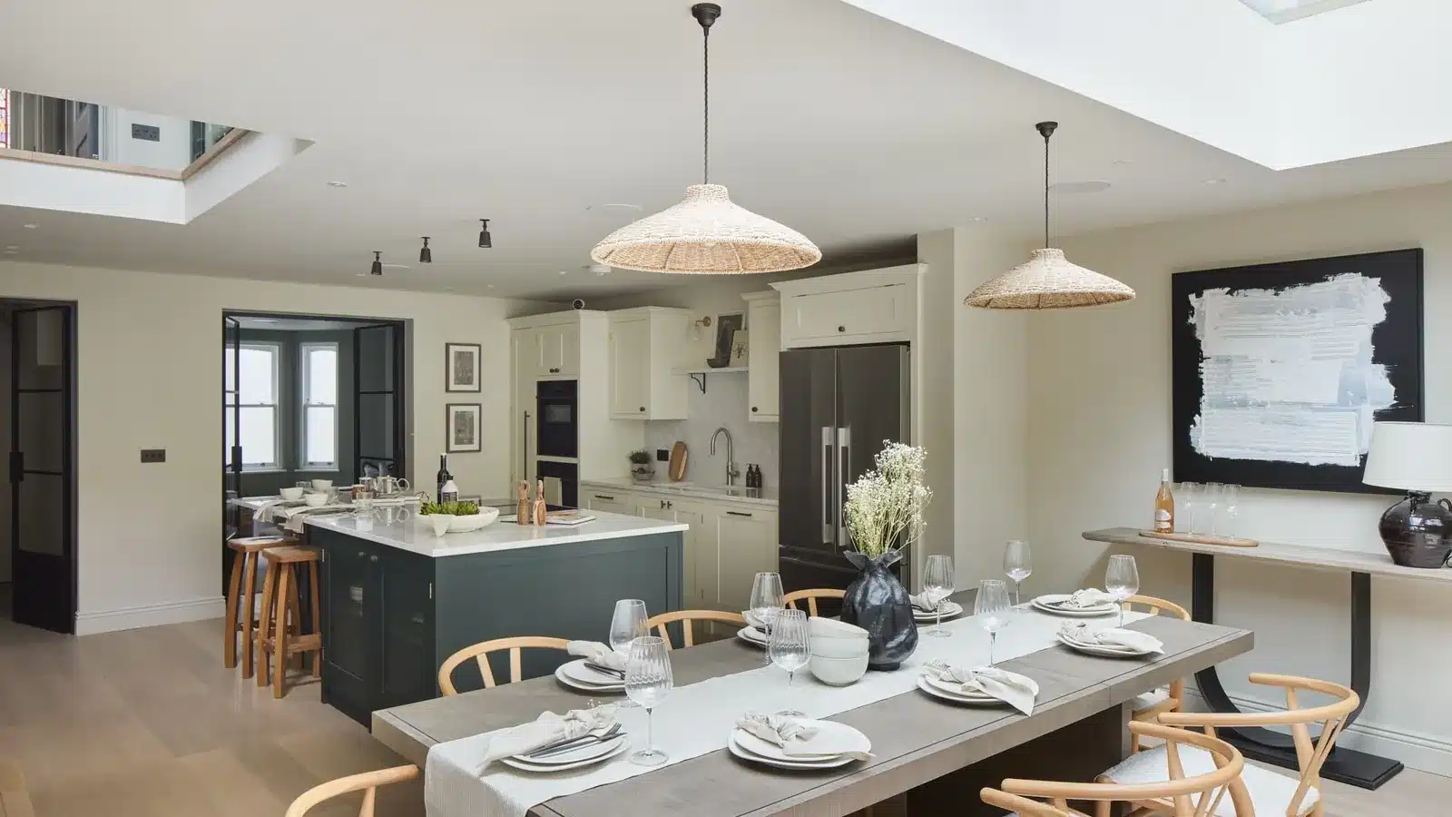 Open-plan kitchen and dining space lit by rooflights in a Fulham house extended with a basement, rear extension and loft conversion