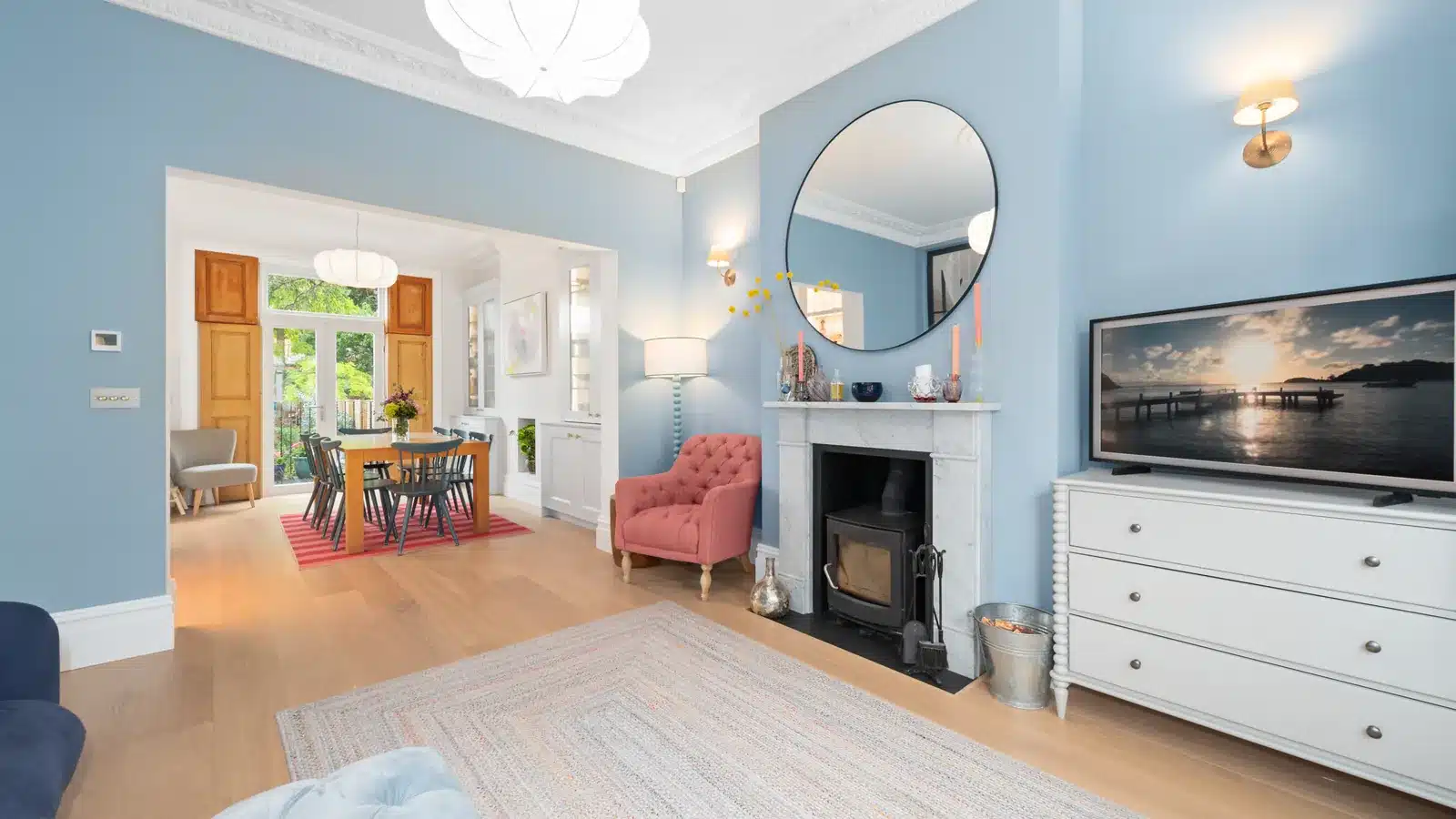 Renovated ground-floor reception room in a Putney period house, with marble fireplace and cornice, looking through to the dining area, Putney SW15