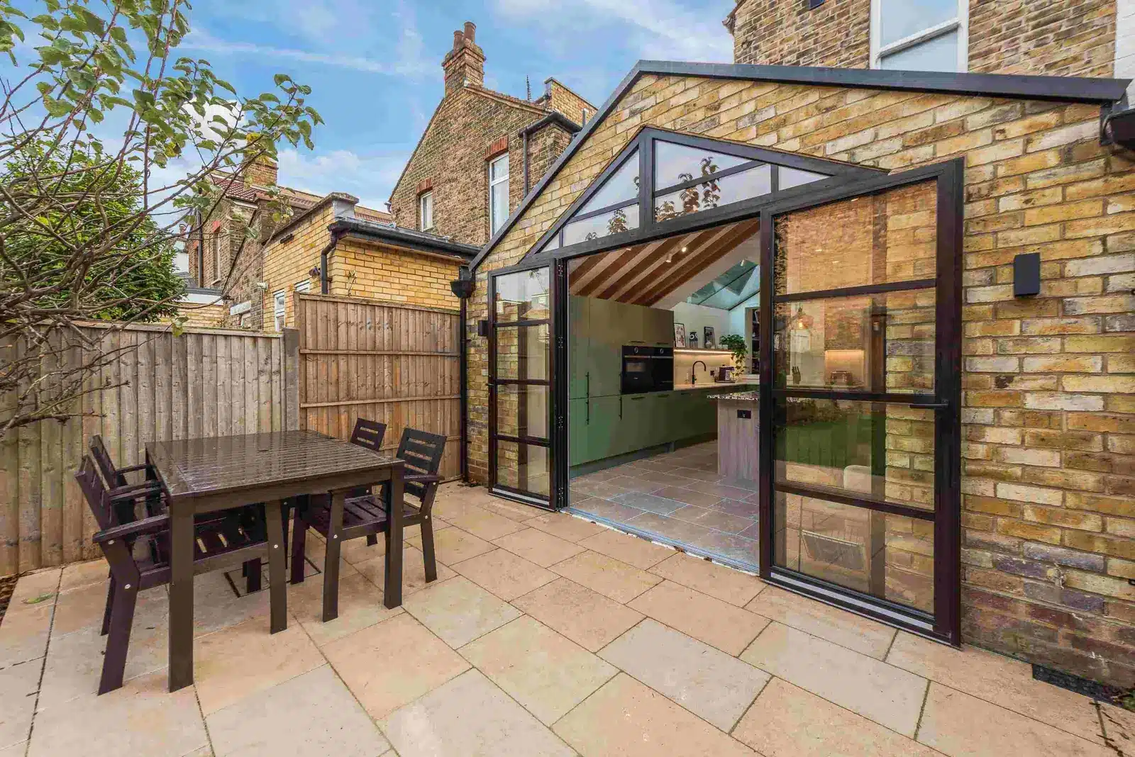 Bi-fold doors opening from a kitchen extension onto a new patio, Brentford TW8