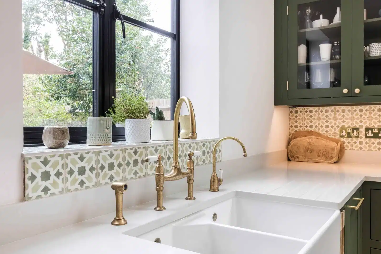 Kitchen sink beneath a window looking out to the garden, kitchen extension in Streatham SW16