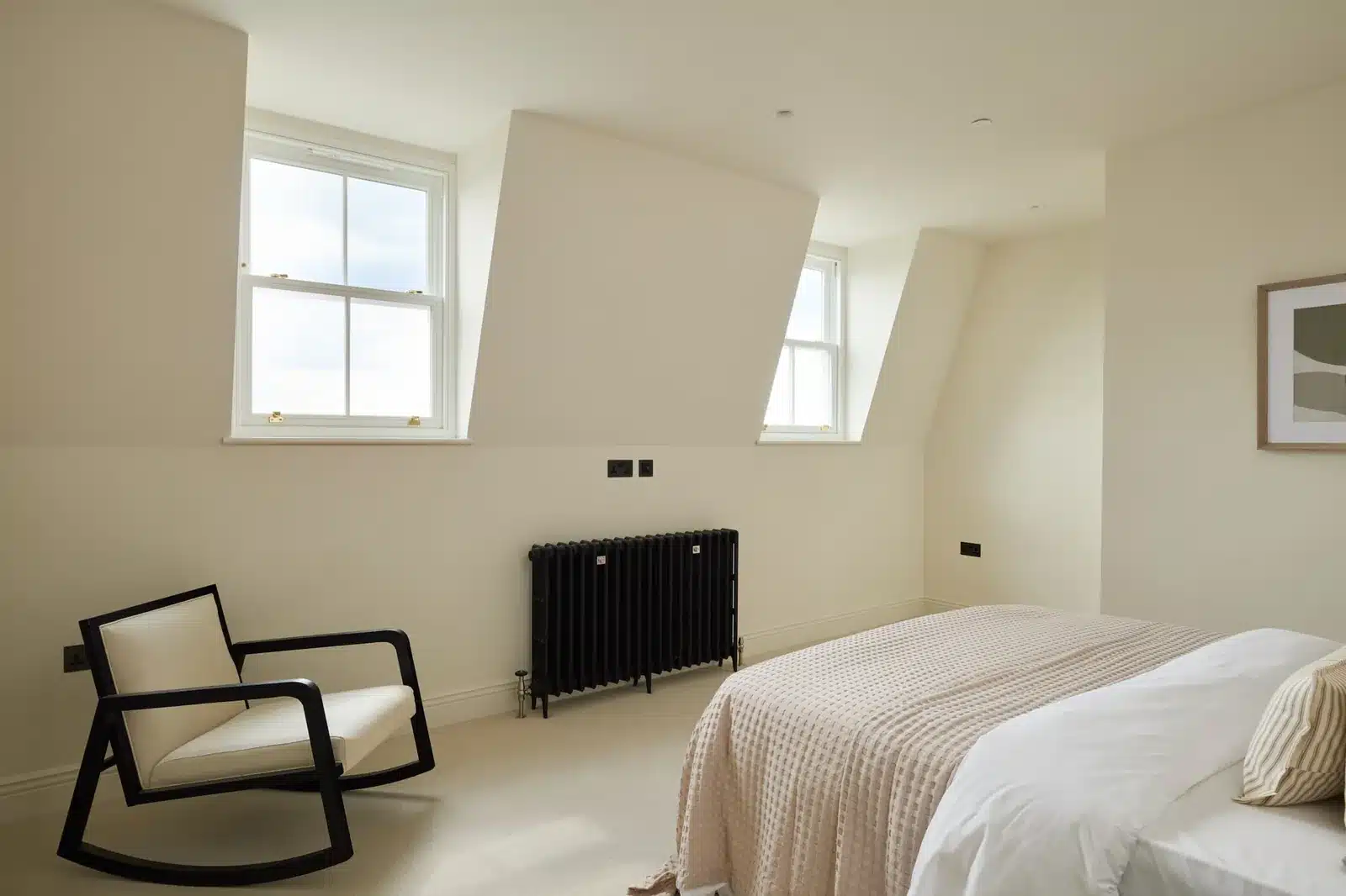 Loft bedroom under a dormer with sash windows, Fulham