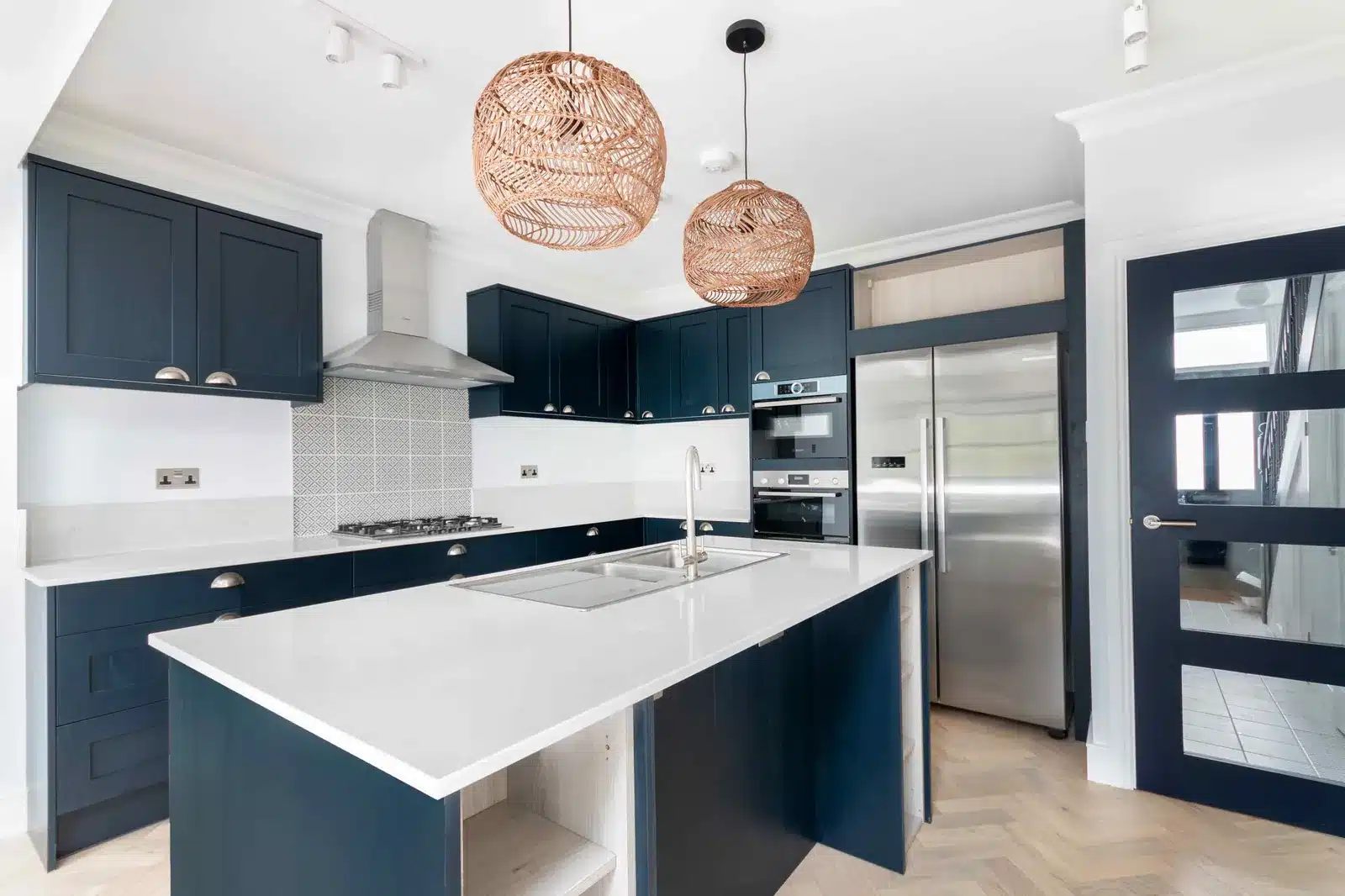 Kitchen island and glazed door in a ground-floor rear extension, Wimbledon