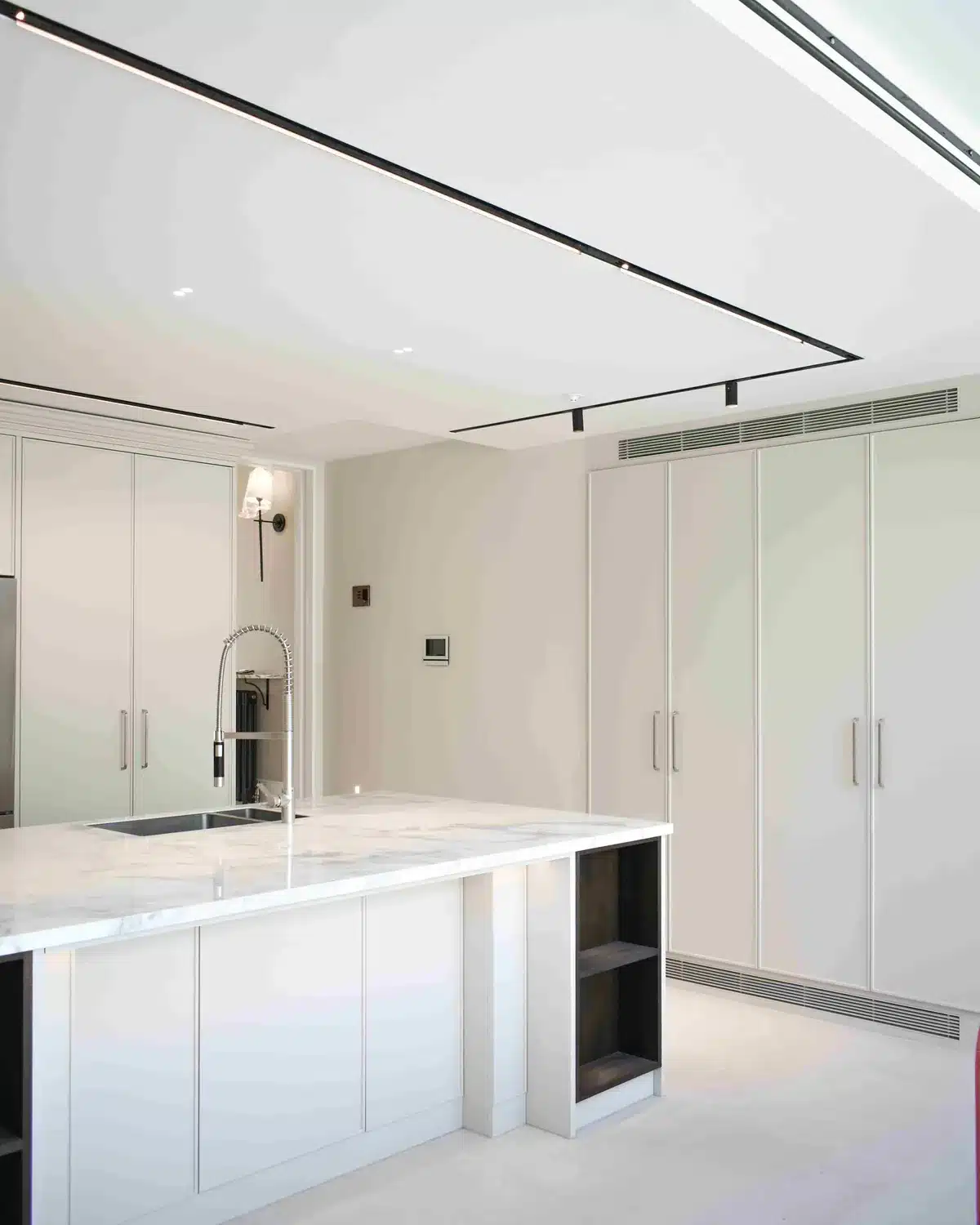 New kitchen with island and full-height cabinets in a whole-house refurbishment, Putney SW15
